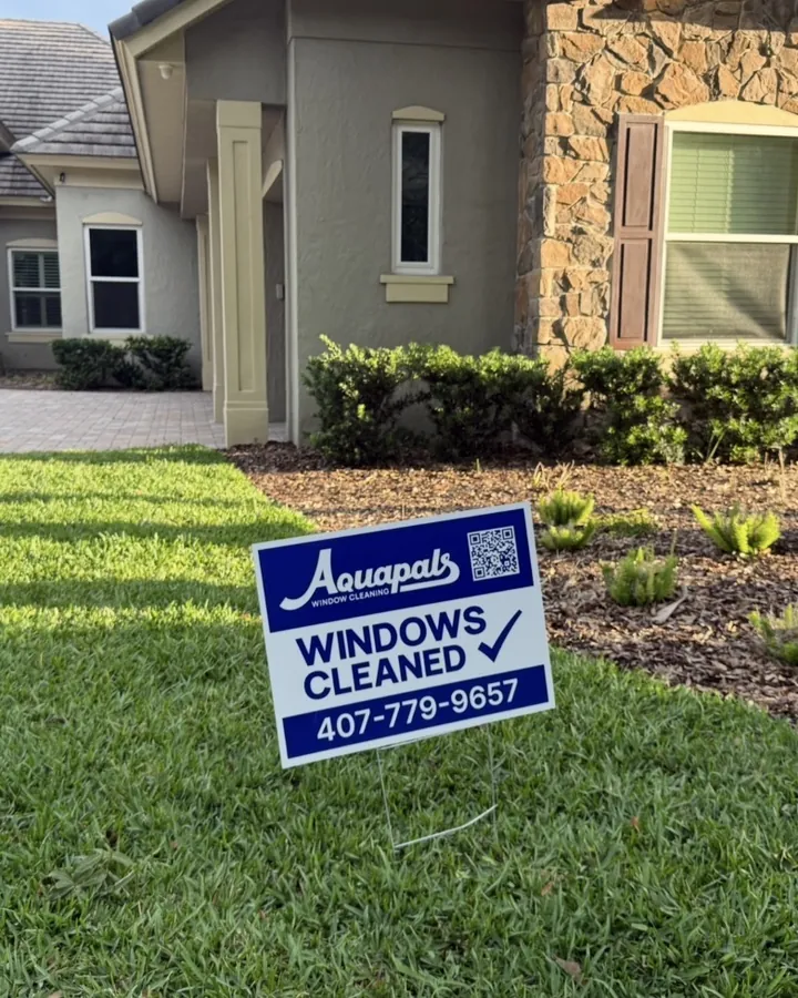 Aquapals “Windows Cleaned” yard sign in front of a Central Florida home